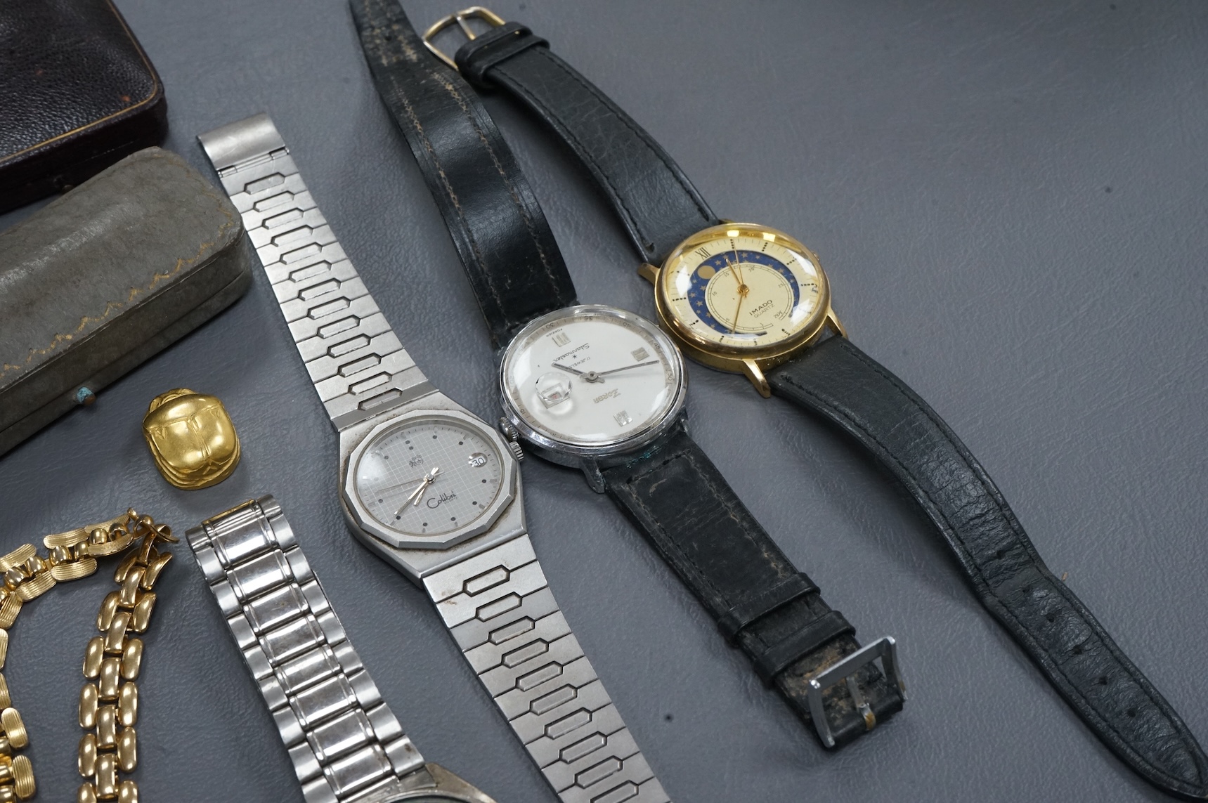 A quantity of assorted costume jewellery and other items including wrist watches, watch movements and a silver vesta case.